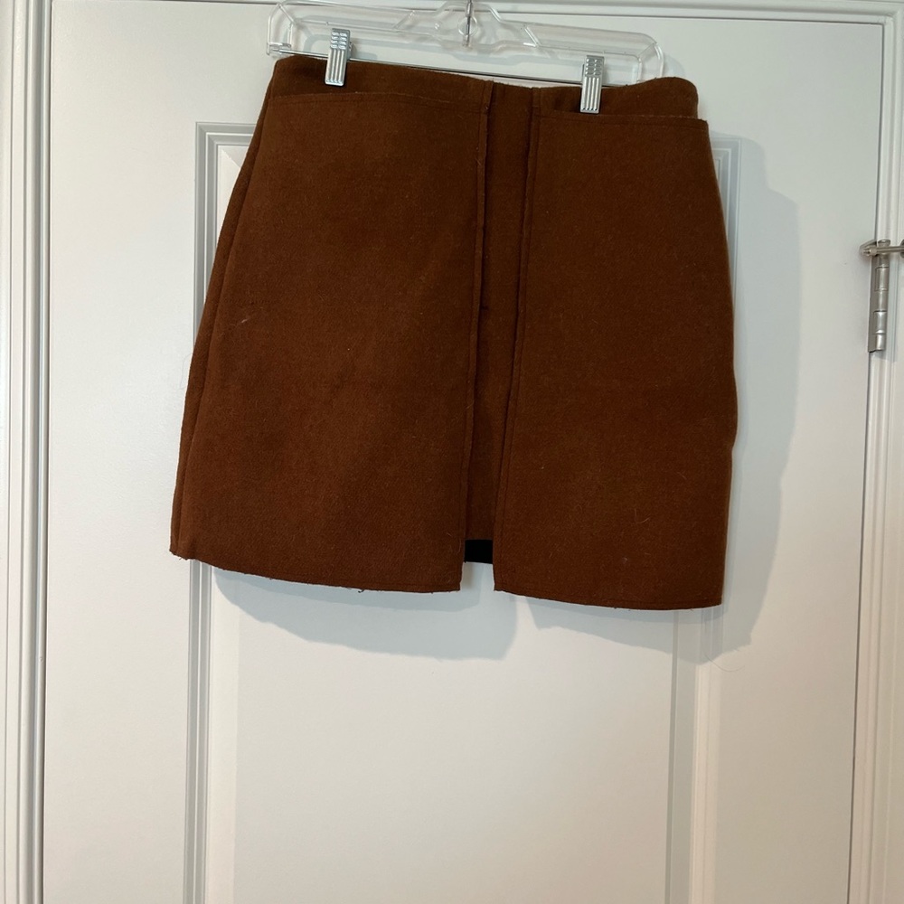 Never worn. Brown/burnt orange mini skirt. Size Large (runs small).